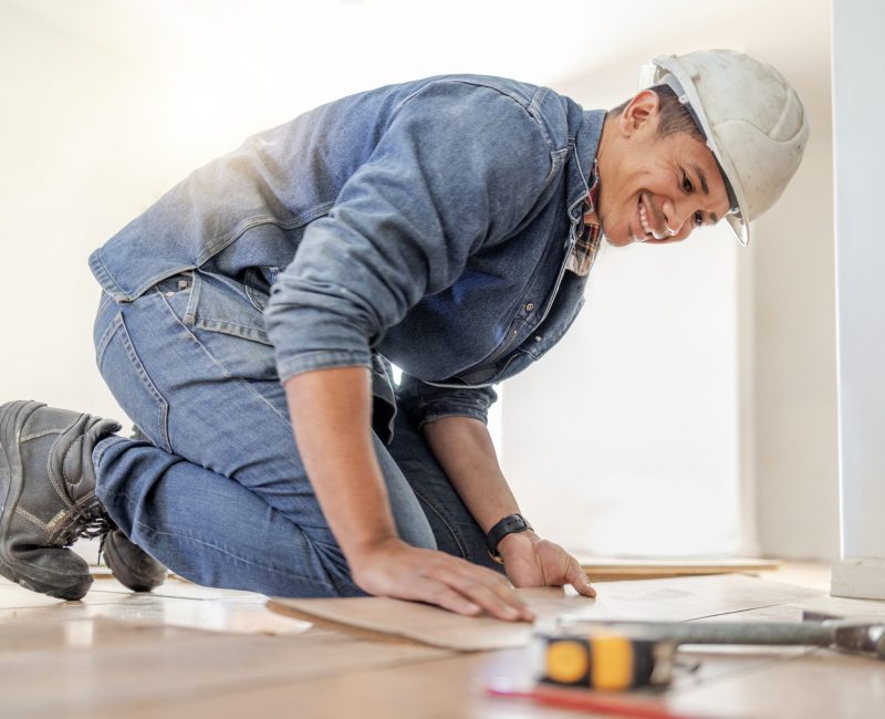 Handyman, wood flooring installation and happy at workplace, industry and home development vision. .
